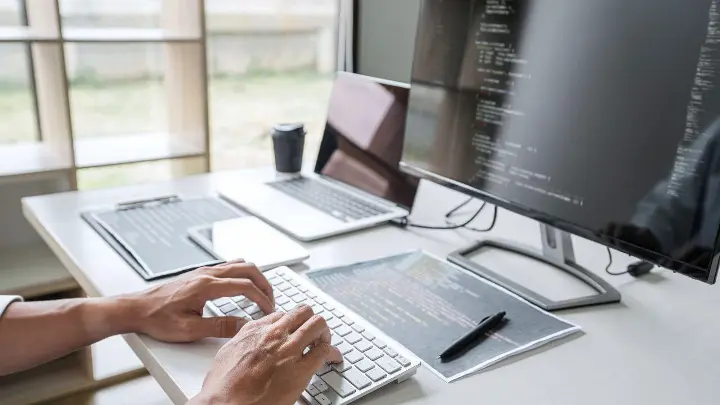 Man coding on desktop