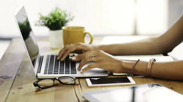 News Blog Image_Typing on Laptop with Glasses_iStockphoto-1182641010