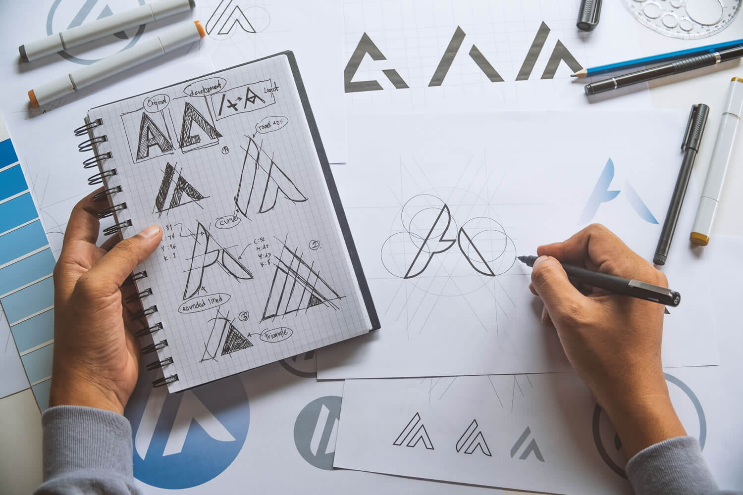 Designer sketching a logo_iStock-1149597075