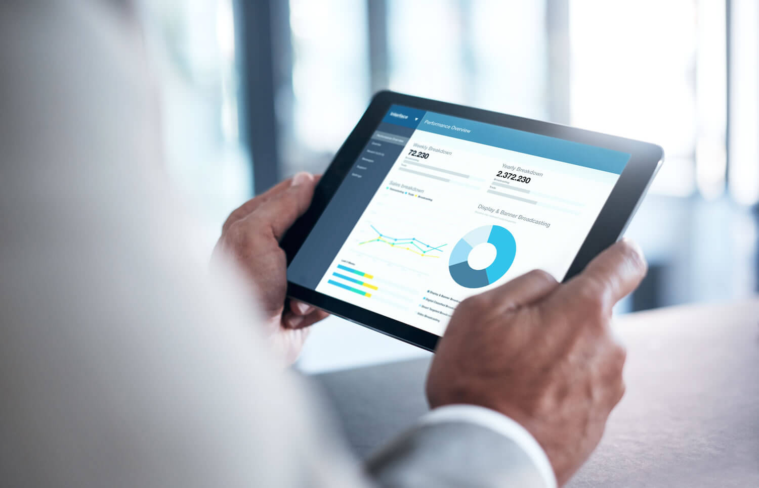 Hands holding tablet with data and stats_Stock-831902178